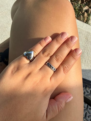 Customer's Heart Ring on hand, shown with a second band ring.