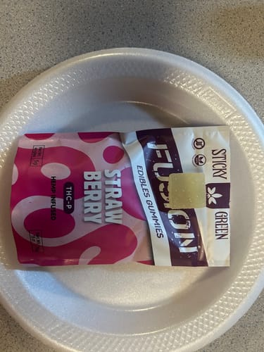 Customer's Fusion Gummies Straw Berry packaging resting on a white plate.