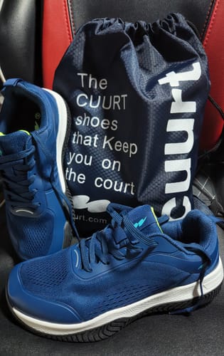 Customer's pair of blue CUURT Muuv court shoes with a branded navy drawstring bag.