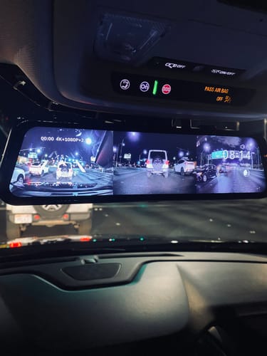 Customer's WOLFBOX G900TriPro rearview mirror showing a bright, clear split-screen view of the road at night.