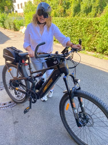 Customer's Lankeleisi MG600 Pro e-mountain bike parked outdoors, with a person standing behind it.
