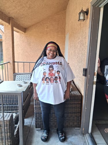 Customer's Tribal Pattern Grandma Grandkids Love shirt worn by a smiling person on a porch.
