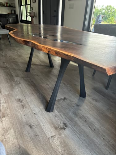 Customer's Hatty table legs installed on a large, live-edge wood dining table in a home setting.