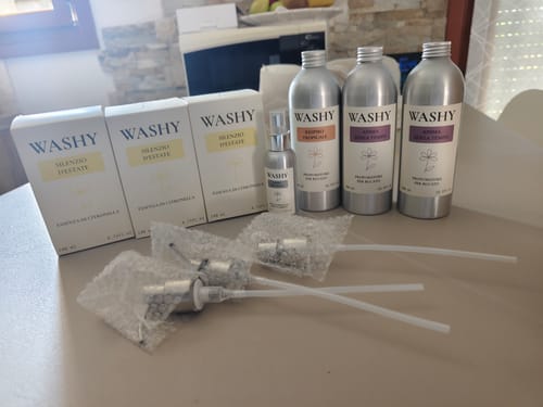 Customer's WASHY PUMP dispensers and bottles arranged on a surface with unopened packaging boxes.
