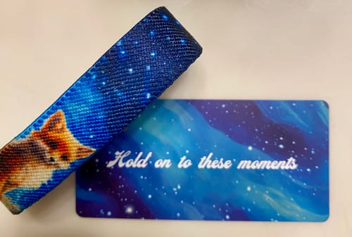 Reviewer's Hold On To These Moments Bracelet with a fox design next to a card featuring the same starry background.