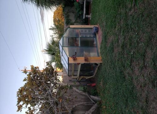 Customer photo review of Erommy 6'x 6'x 6.6' Walk-in Greenhouse Plant House UV Protection with Roof Vent & Rain Gutters