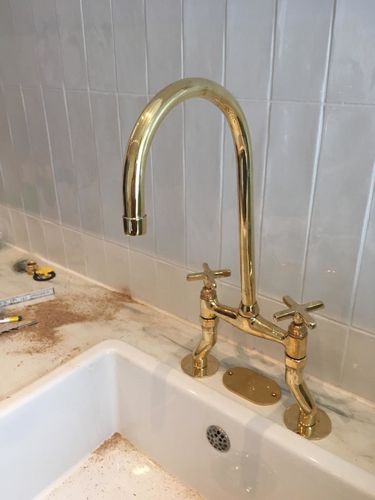 Customer photo review of Katarina Bridge Kitchen Faucet Unlacquered, Curved Legs With Brass Cross Handles
