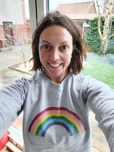 grey jumper with rainbow
