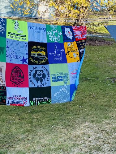 T-shirt quilt with running, wrestling themes by Laura from WI