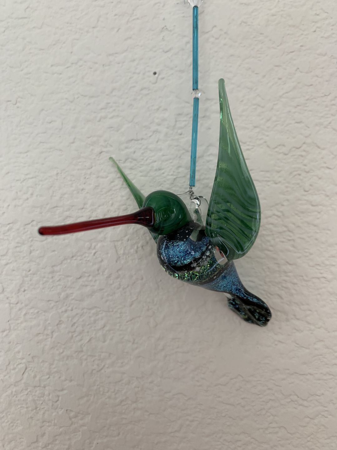 Customer photo review of Dichroic Twist Glass Hummingbird with Infused Ash