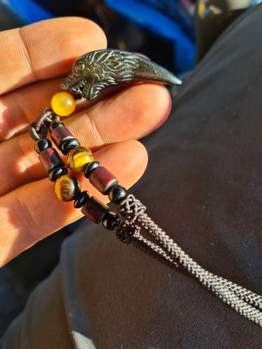 Customer photo review of Carved Obsidian Wolf Fang