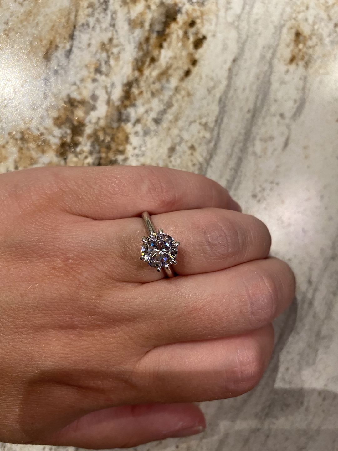 Customer photo review of S925 Moissanite/ Simulated Diamond 2.0 Carat Round Cut Solitaire Engagement Ring In Sterling Silver