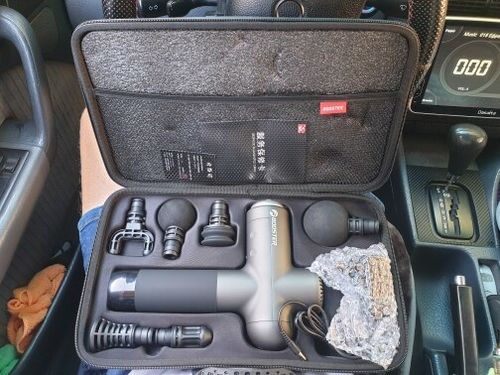 Customer photo review of BOOSTER Premium Massage Gun With 6 Massage Heads - Smart Hit Technology