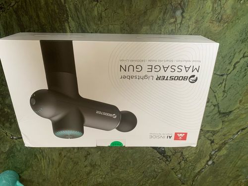 Customer photo review of BOOSTER Premium Massage Gun With 6 Massage Heads - Smart Hit Technology
