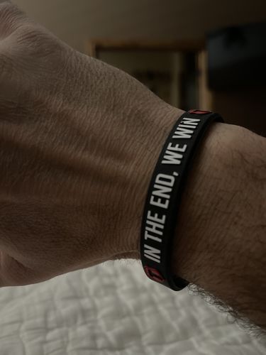 Customer photo review of "In The End, We Win!" Wristband