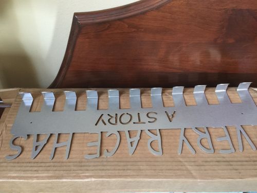 Customer photo review of Every Race Has a Story Medal Hanger