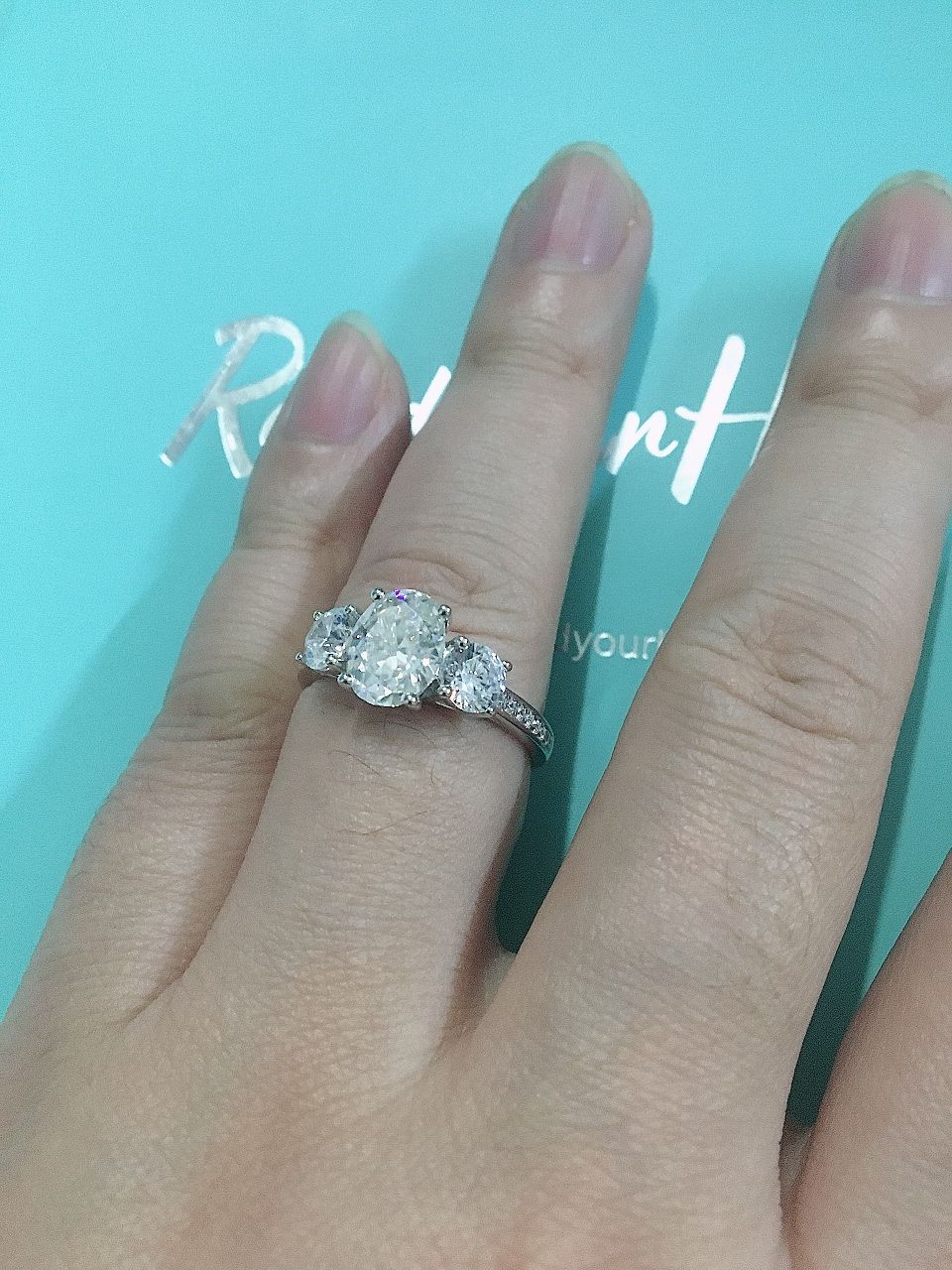 Customer photo review of Three Stone Oval Moissanite Channel-Set Engagement Ring