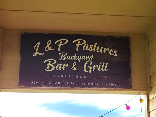 Customer photo review of Backyard Bar & Grill Sign