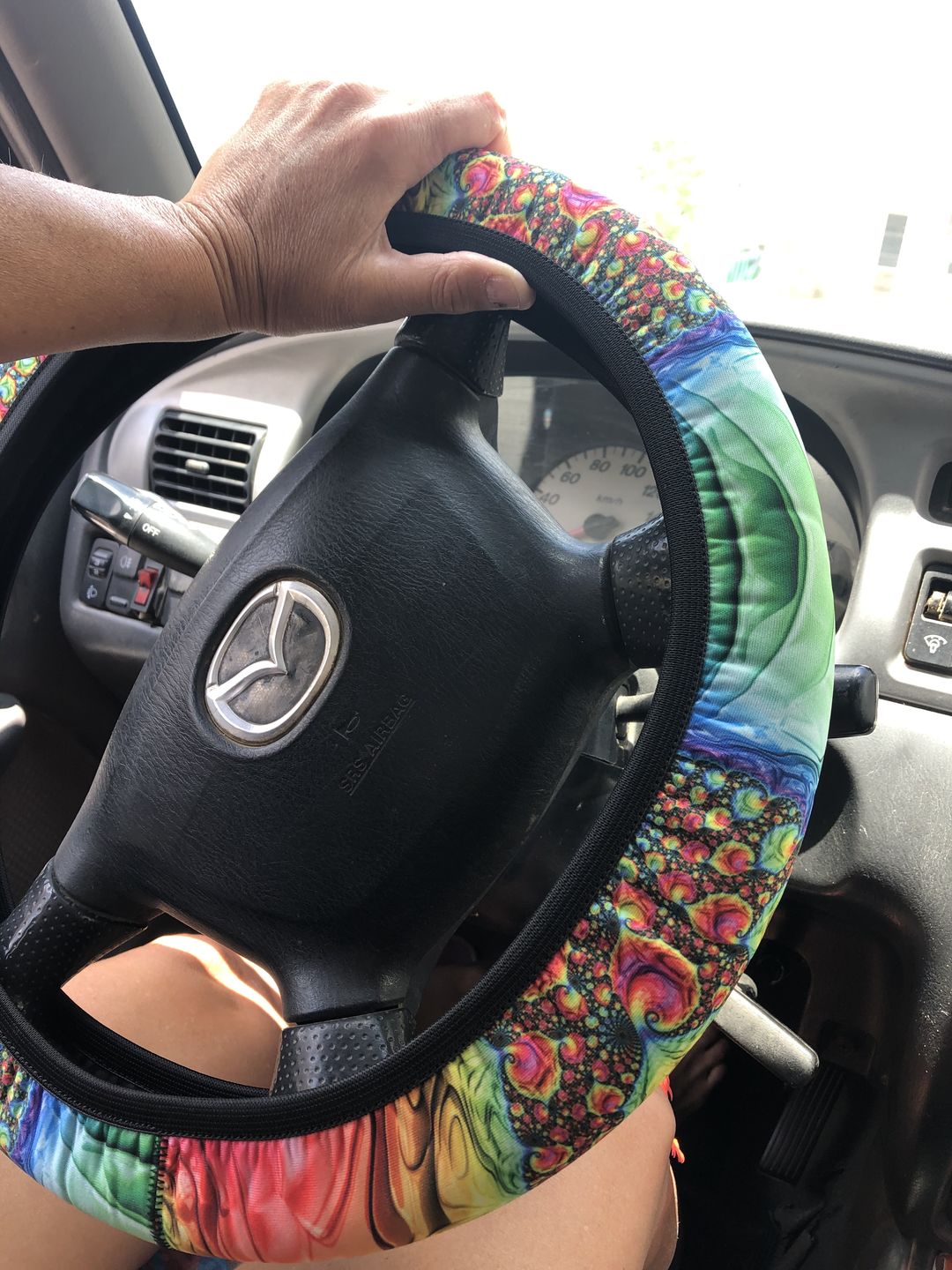 Customer photo review of Happy Rainbow Steering Wheel Cover
