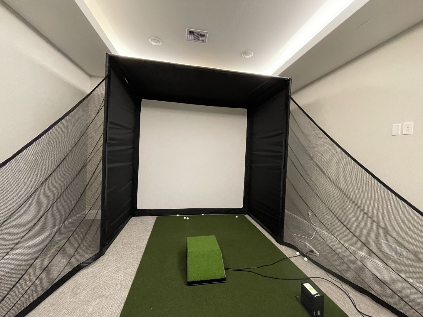 Finished room enclosure bay, a customer's golf simulator room