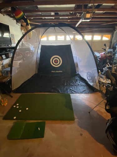 Customer photo review of Golf Practice Driving Net for Indoors and Outdoors | Tri-Turf Hitting Mat