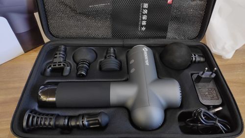 Customer photo review of BOOSTER Premium Recovery Massage Gun With 6 Massage Heads - Smart Hit Technology