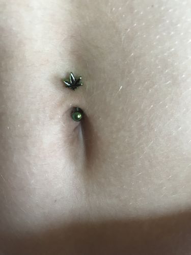 Customer photo review of 16g Petite Metallic Green Pot Leaf Reversible Belly Bar