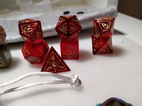 Customer photo review of URWizards D&D Garnet Glass Engraved Dice Set Astrology Style