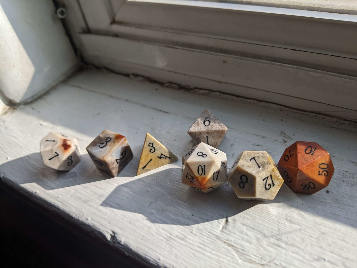 Customer photo review of URWizards D&D Coral Fossil Gemstone Engraved Dice Set