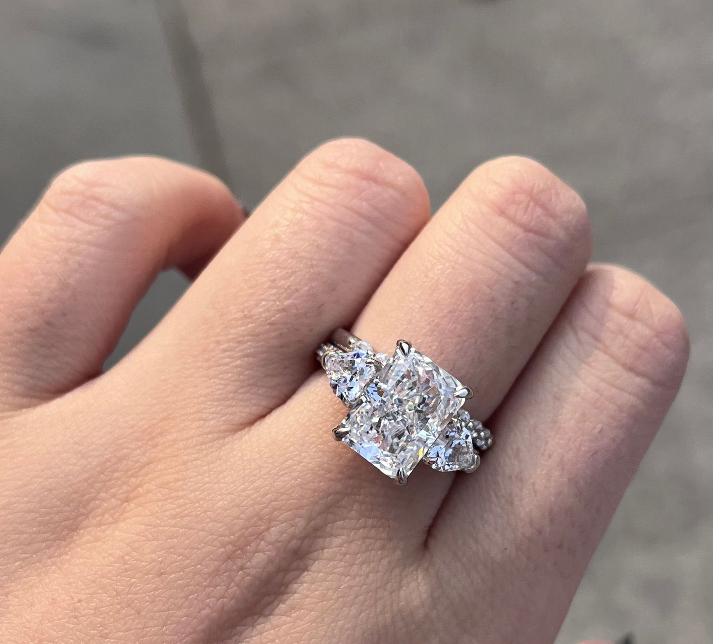 Customer photo review of Louily 5.0 Carat Radiant Cut Three Stone Engagement Ring With Two Heart Cut Side Stones