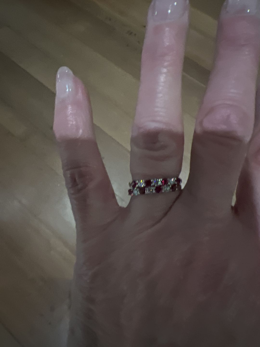 Customer photo review of Seven Stone Moissanite and Ruby Wedding Band Ring In Sterling Silver