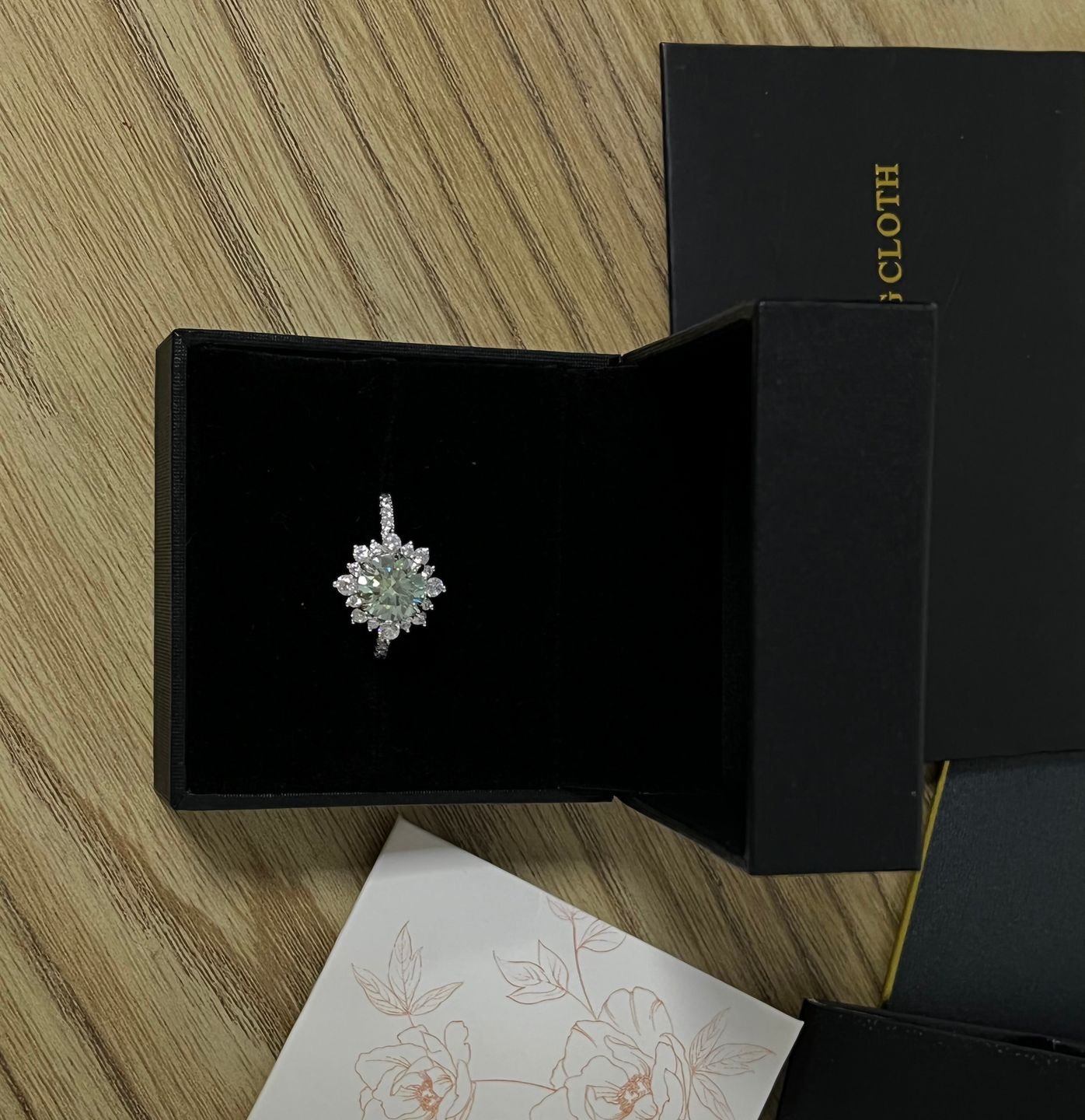 Customer photo review of S925 Moissanite 2 Ct Snowflake Design Halo Round Cyan Blue Stone Engagement Ring