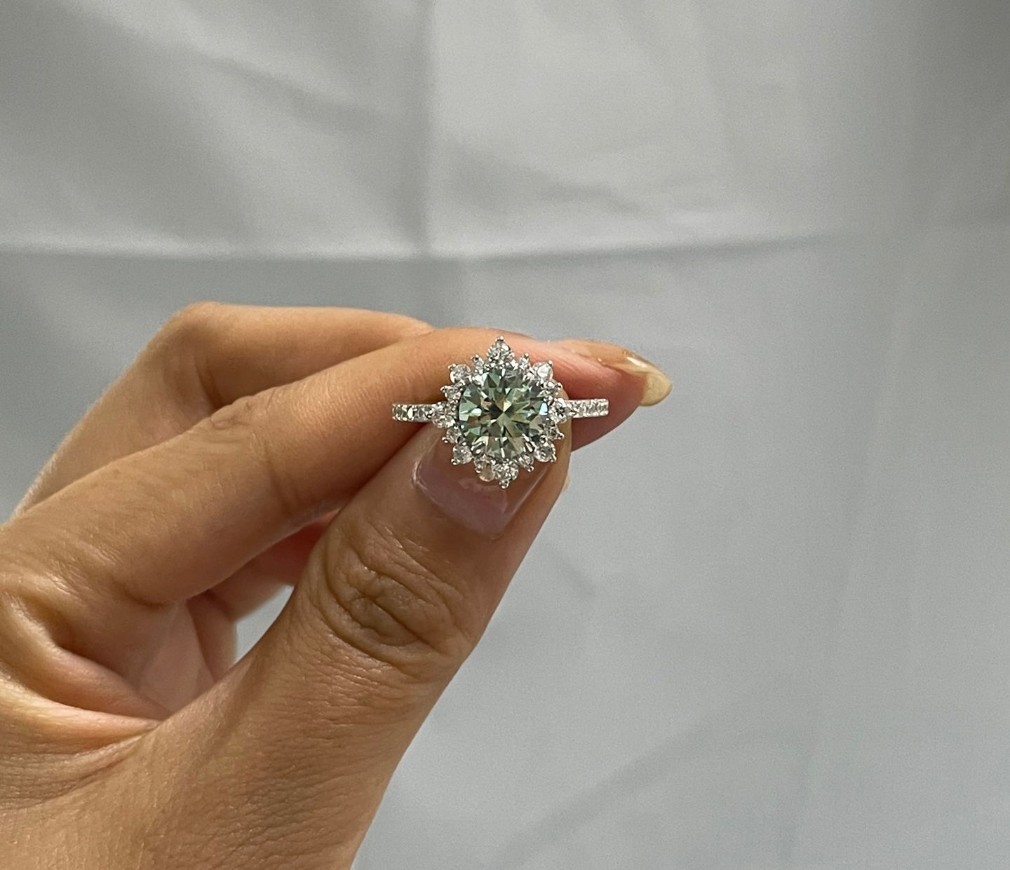 Customer photo review of S925 Moissanite 2 Ct Snowflake Design Halo Round Cyan Blue Stone Engagement Ring