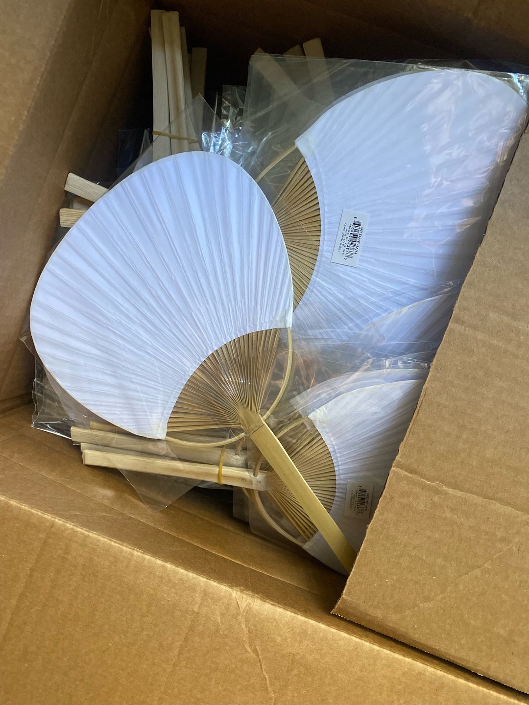 Customer photo review of 9" White Paddle Paper Hand Fans for Weddings (10 Pack)
