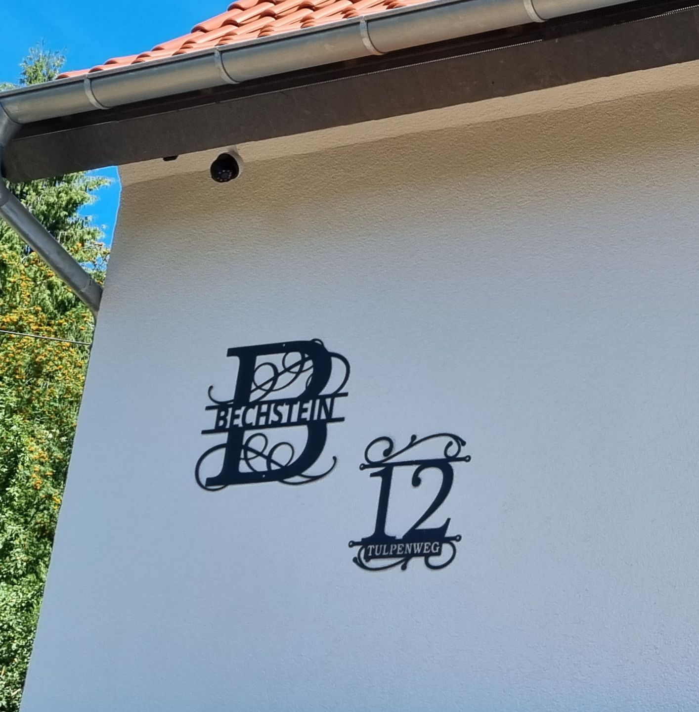 Customer photo review of Hausnummer Türschild mit Ornament und Familiennamen aus edlem Stahl