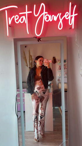 Customer photo review of Treat Yourself neon sign