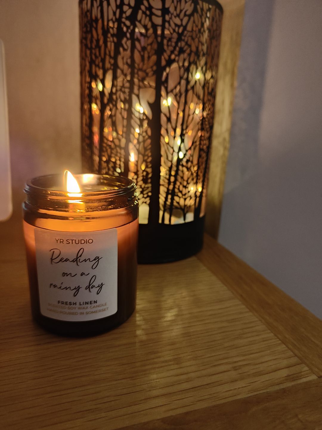 Customer photo review of “Reading on a rainy day” Fresh Linen Candle in Amber Jar
