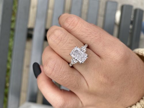 Customer photo review of Louily 5.0 Carat Radiant Cut Three Stone Engagement Ring With Two Heart Cut Side Stones