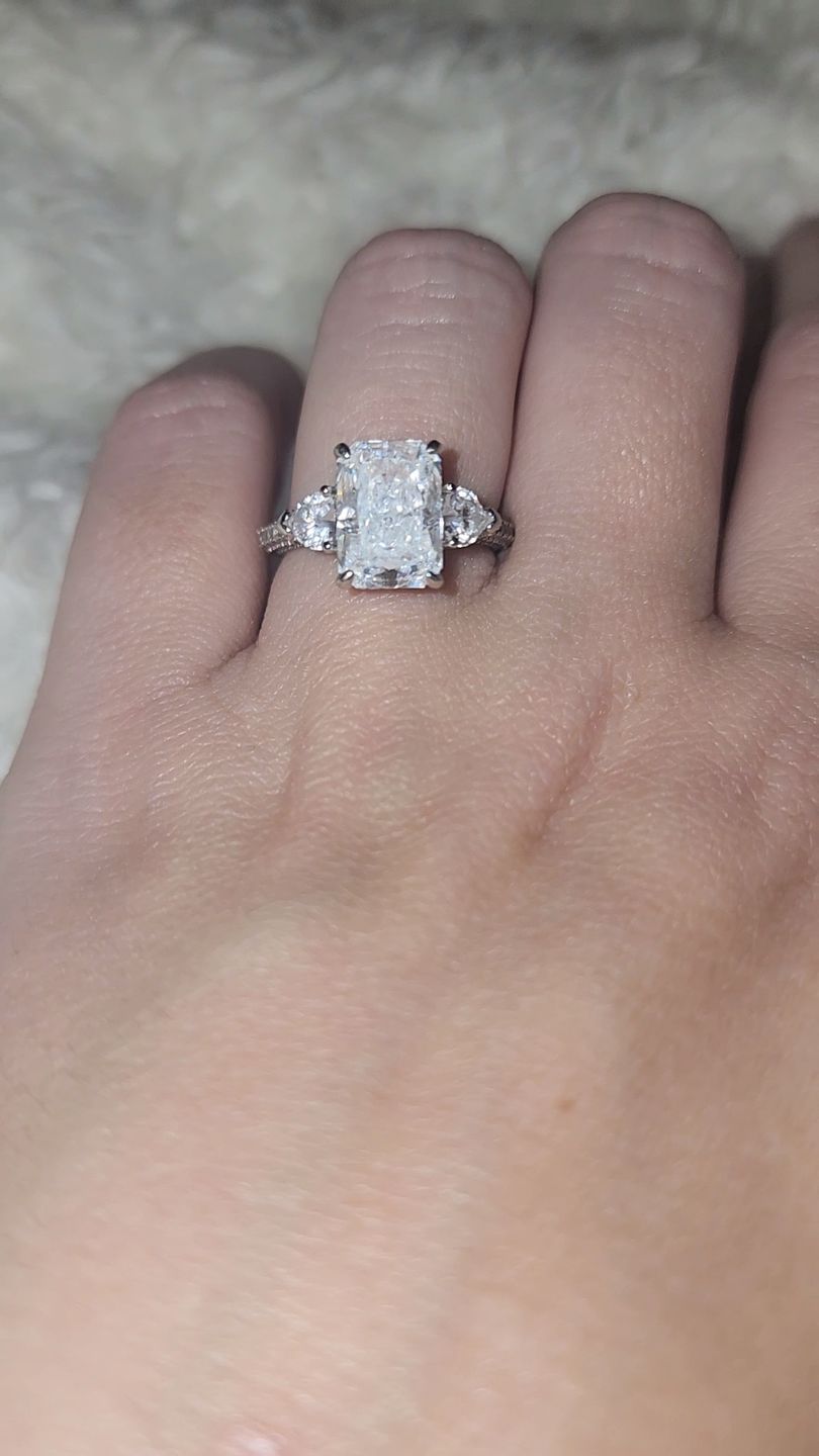 Customer photo review of Louily 5.0 Carat Radiant Cut Three Stone Engagement Ring With Two Heart Cut Side Stones