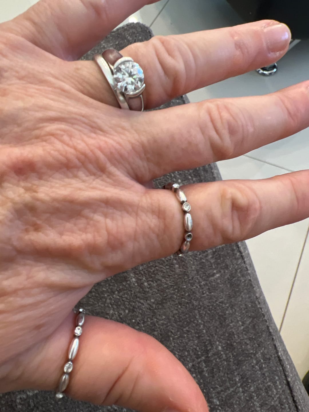 Customer photo review of Solitaire Moissanite Half Bezel Set Sterling Silver Engagement Ring