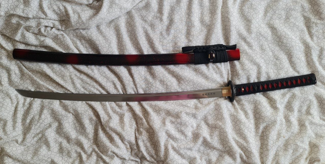 Customer photo review of Hand Forged 1060 High Carbon Steel Blade Full Tang Hawk Samurai Katana Sword