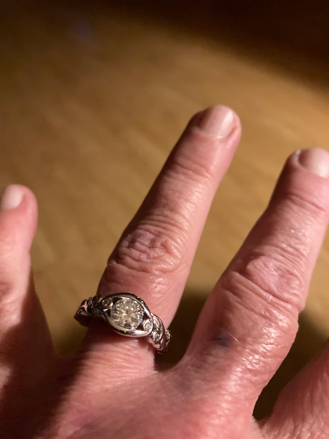 Customer photo review of Bezel Set Round Moissanite Scroll Accents Engagement Ring