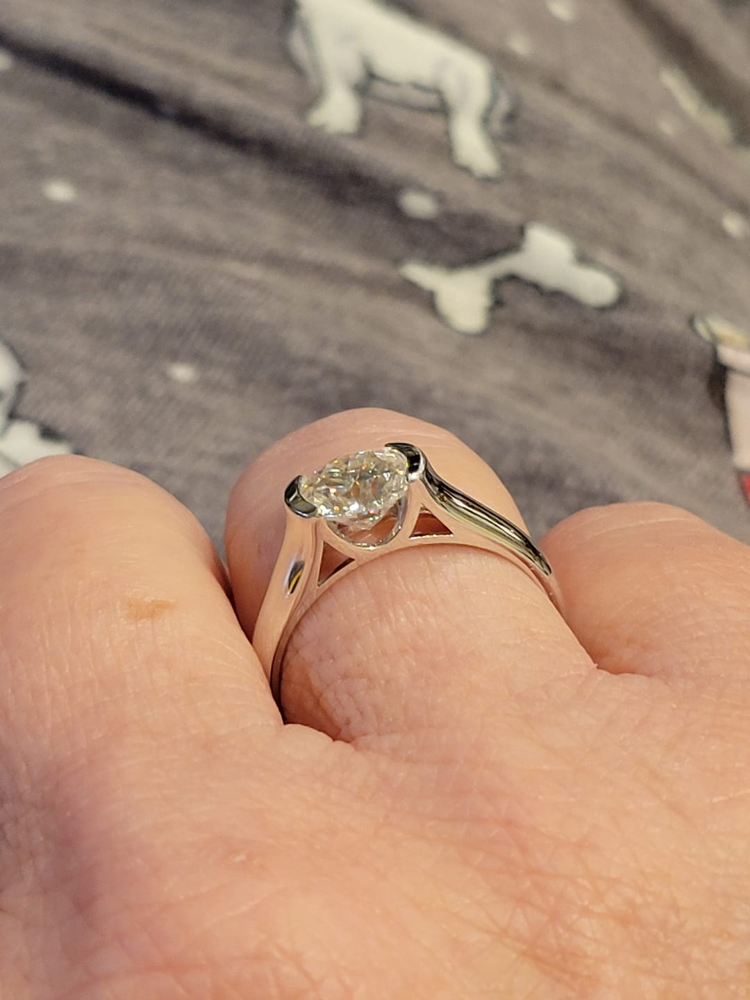 Customer photo review of Solitaire Moissanite Half Bezel Set Sterling Silver Engagement Ring