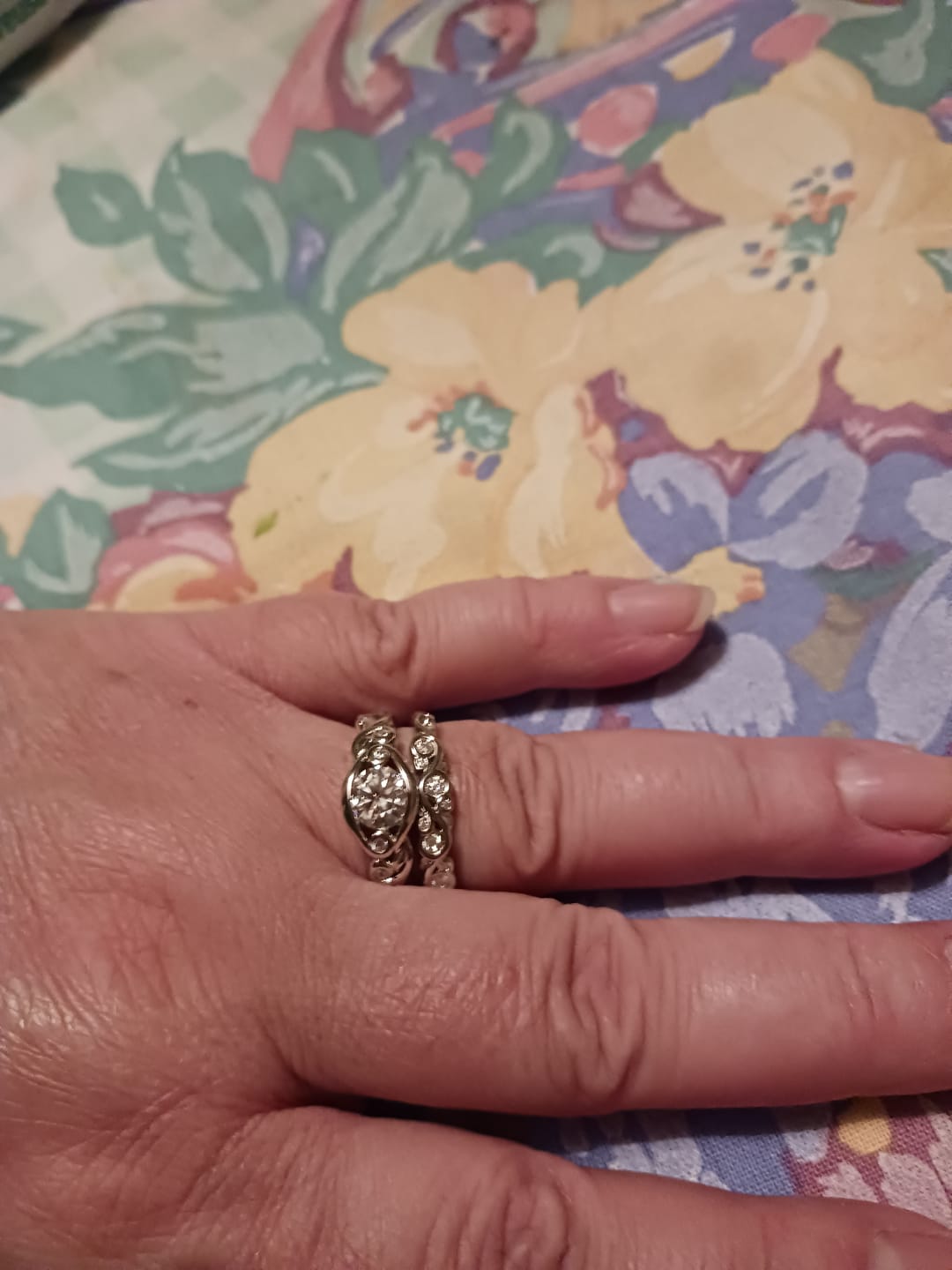 Customer photo review of Bezel Set Round Moissanite Scroll Accents Wedding Band Ring In Sterling Silver