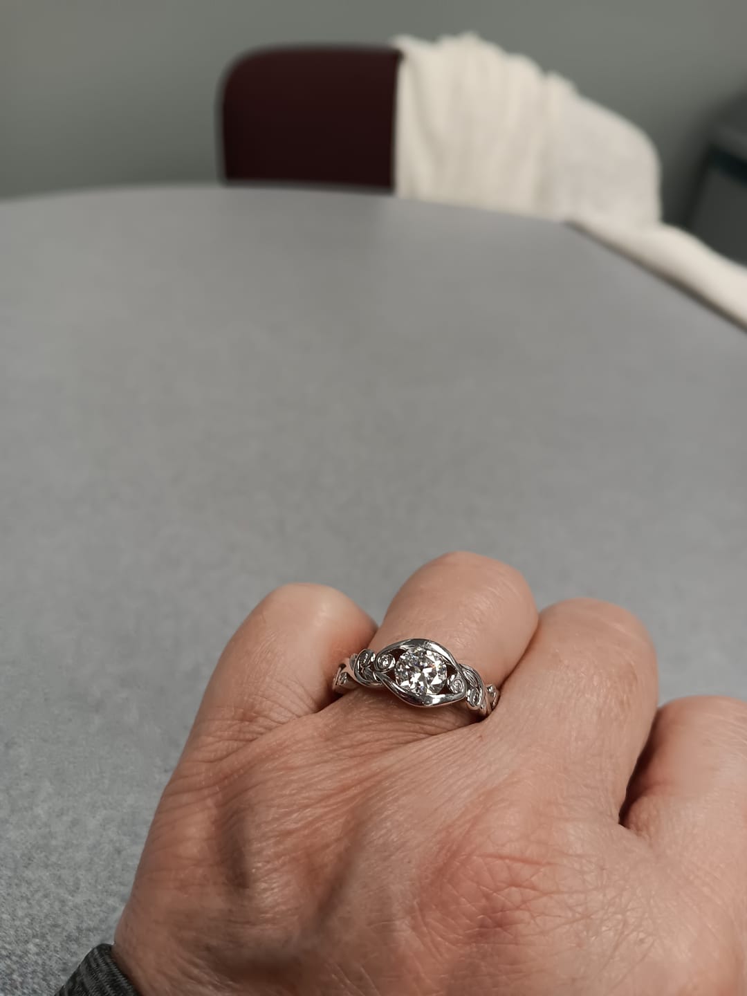 Customer photo review of Bezel Set Round Moissanite Scroll Accents Engagement Ring