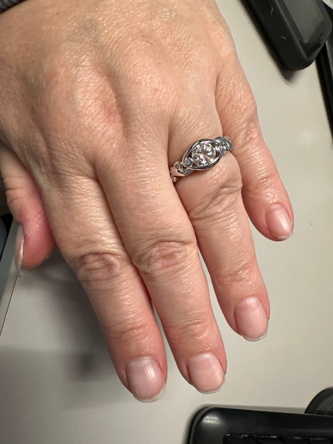 Customer photo review of Bezel Set Round Moissanite Scroll Accents Engagement Ring