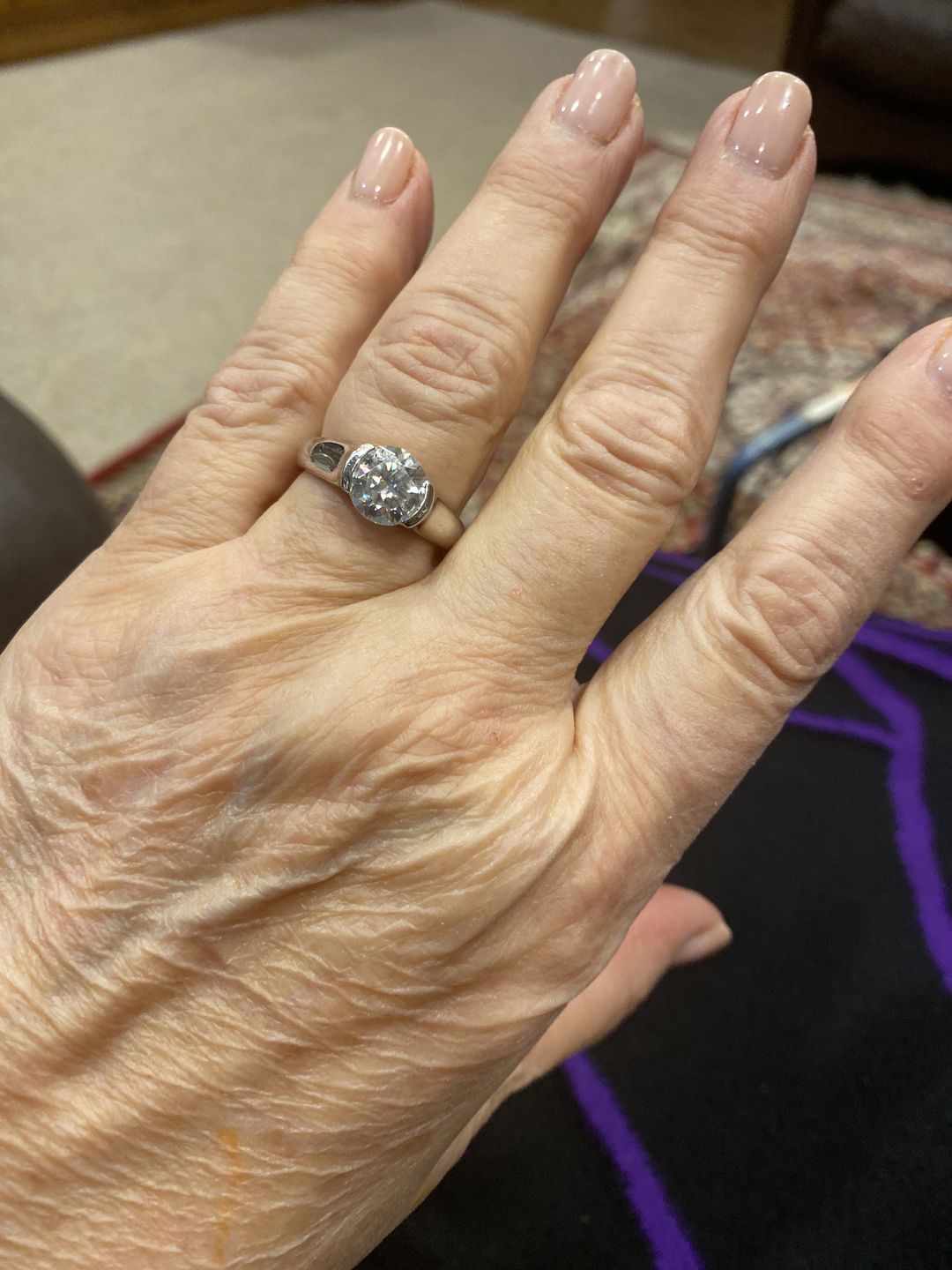Customer photo review of Solitaire Moissanite Half Bezel Set Sterling Silver Engagement Ring
