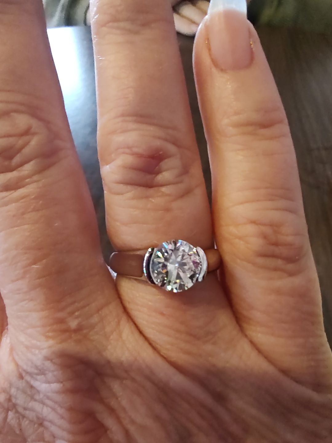 Customer photo review of Solitaire Moissanite Half Bezel Set Sterling Silver Engagement Ring