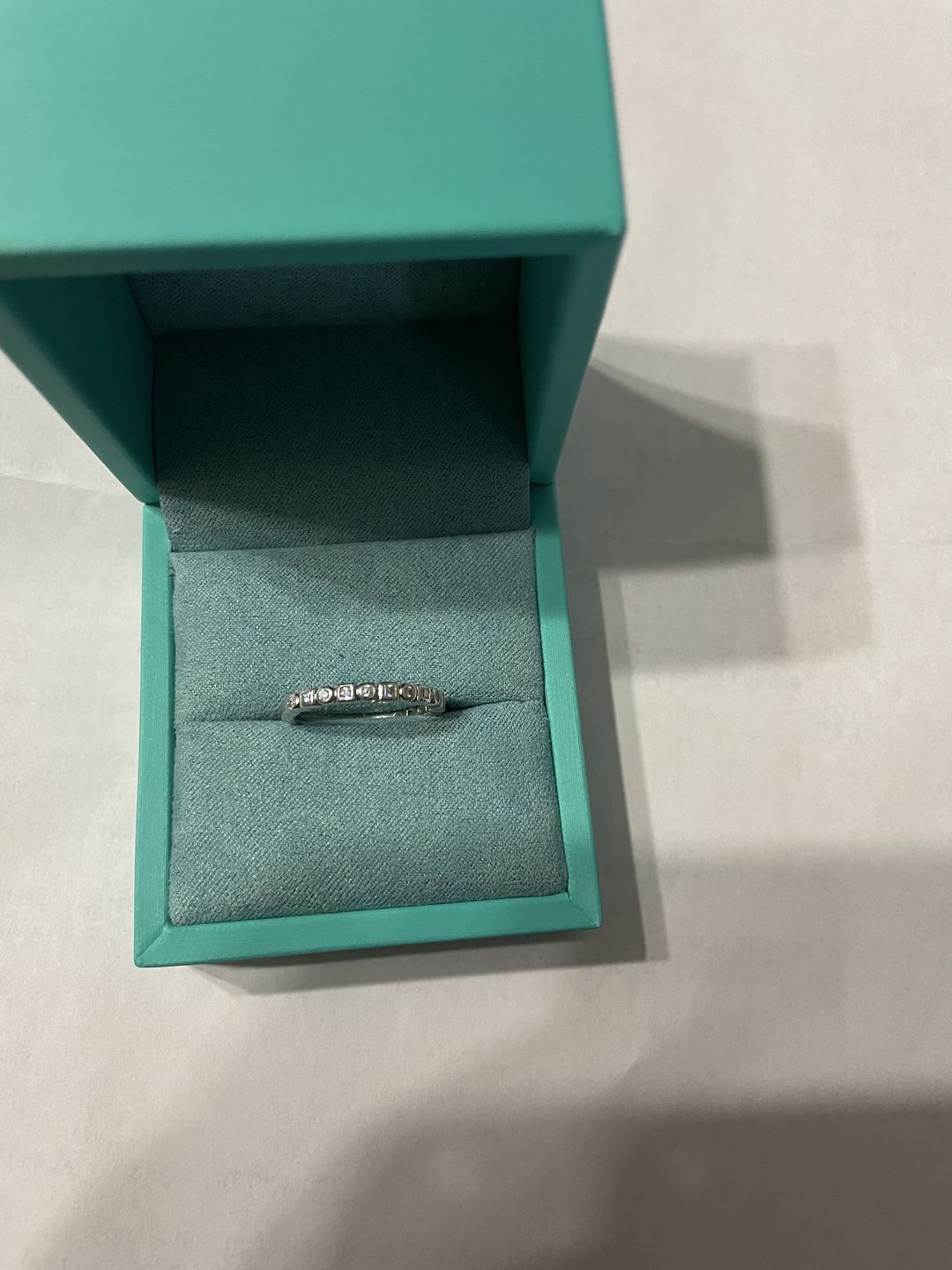 Customer photo review of Alternating Round And Princess Cut Moissanite Bezel Set Half Eternity Wedding Band