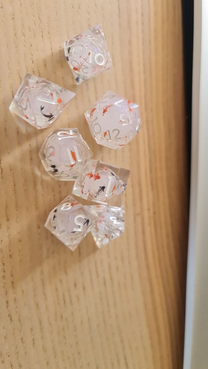 Customer photo review of URWizards D&D Starry Liquid Heart Resin Engraved Dice Set Koi Fish